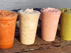 Four blended fruit smoothies lined up