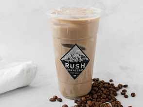 Iced latte in a Rush Espresso cup with coffee beans