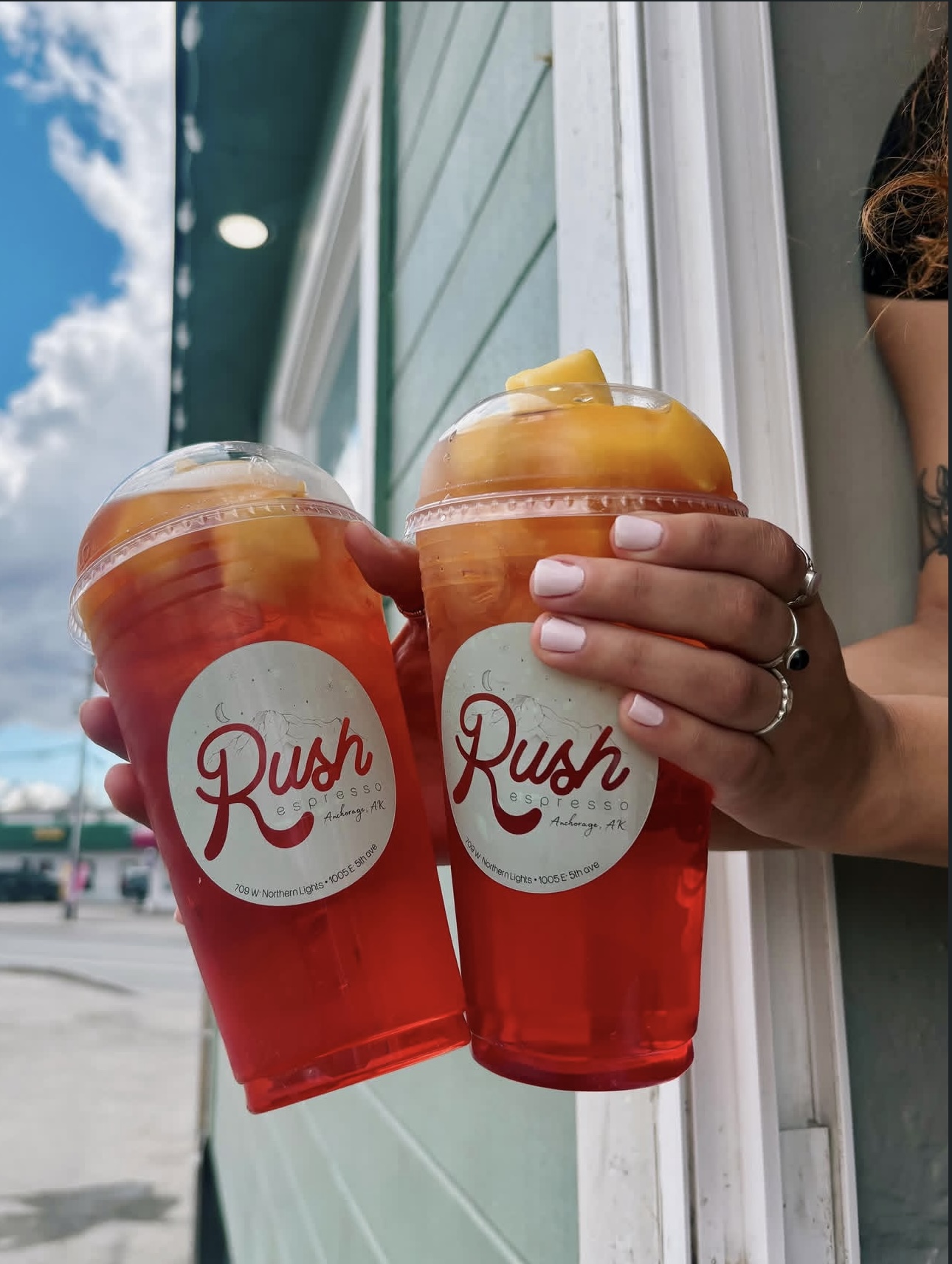 Two red fruit refreshers held outside the Rush window
