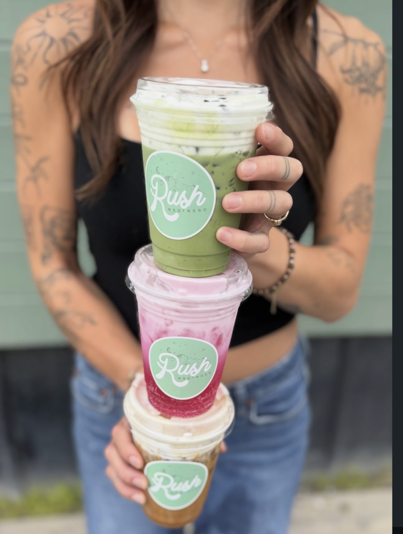 Three stacked Rush Espresso cups — matcha, pink drink and iced coffee